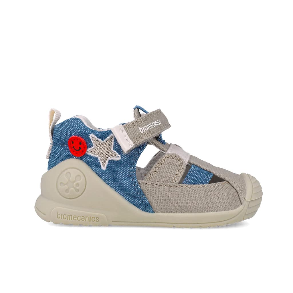 Children's sneaker with blue denim, beige straps, star patch and red smiley badge, beige sole, Biomecanics branding on strap