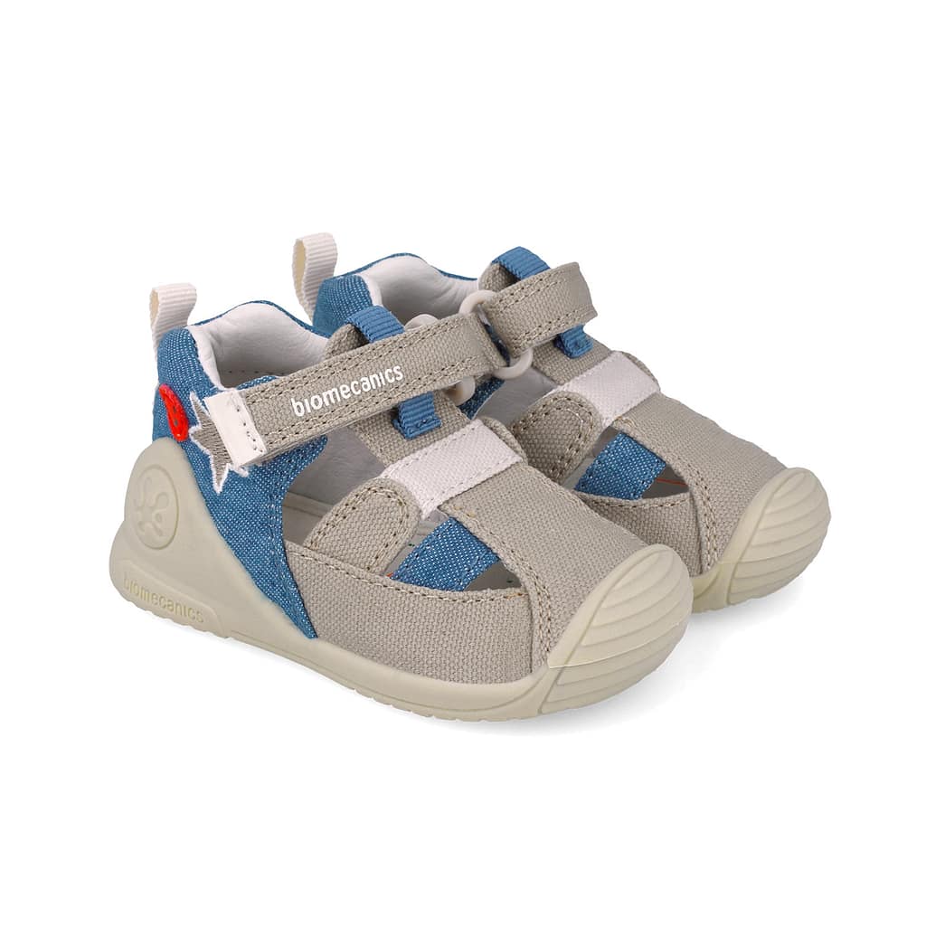 Kids' beige and blue open-toe sandal with Velcro straps, Biomecanics brand visible on strap.