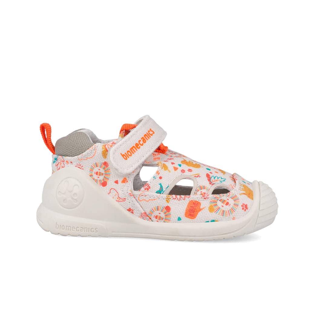 White patterned kids' sneaker with orange accents and a Velcro strap that reads 'biomecanics'.