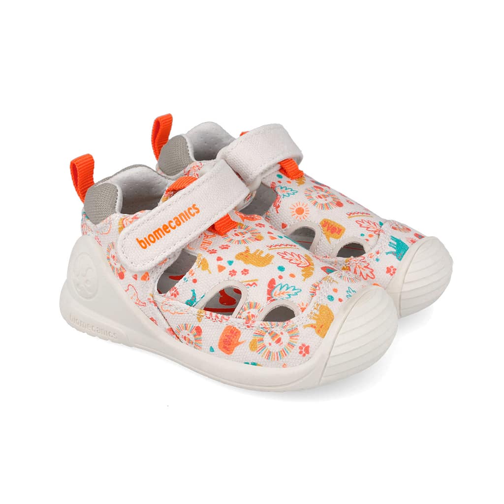 Kids' white sandals with an orange logo strap and bright summer print, open-toe design and velcro closure on each shoe