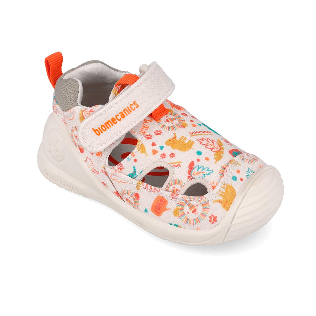 White kids' sneaker with a colorful print and orange accent, featuring a Velcro strap labeled 'biomecanics'.