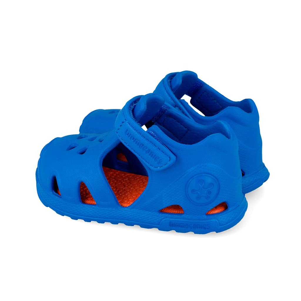 Blue kids' water sandal with orange inner sole and a Velcro strap.
