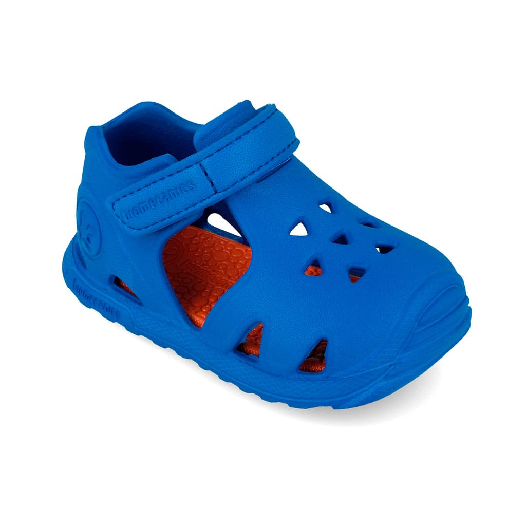 Blue children's sandal with Velcro strap and orange textured insole, closed-toe with cutouts for breathability